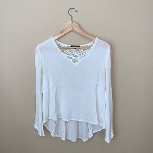 A blouse like top with lace design in the back.